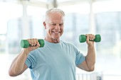 Senior man using weights