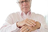 Senior man rubbing painful hand