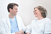 Doctor smiling at Woman patient