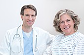 Doctor and female patient smiling towards camera