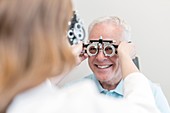 Optician testing man's eyesight