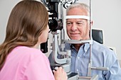 Optician testing man's eyesight