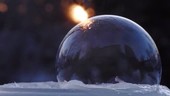 Ice crystals forming on a soap bubble