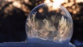 Ice crystals forming on a soap bubble