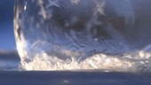 Ice crystals forming on a soap bubble