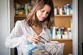 Woman sorting old medicines