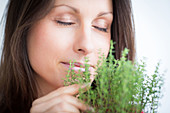 Woman inhaling thyme fragrance