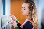 Woman adjusting a thermostatic radiator valve