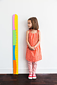5-year-old girl looking at a height gauge