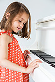 5-year-old girl playing the piano
