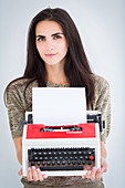 Woman holding a typewriter