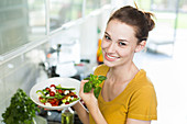 Woman preparing a Mediterranean salad