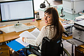 Woman in wheelchair working