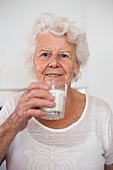 Elderly woman drinking milk