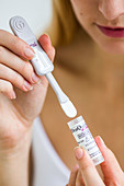 Woman using Oraquick HCV Hepatitis C Rapid Antibody Test