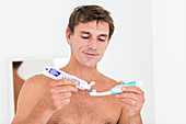 Woman brushing her teeth with electric toothbrush
