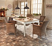 Rattan armchair, tiled floor and Advent arrangement in country-house dining area