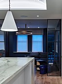 Marble kitchen island and living room in shades of blue and black