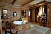 Wood-clad bathtub in rustic, country-house-style bathroom