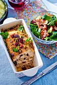 Chicken terrine with cherries and pistachios, served with spinach and bacon salad