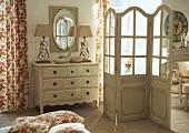 Chest of drawers and screen in romantic bedroom