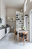 White, modern kitchen with high ceiling and clerestory windows