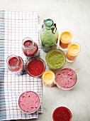 Various homemade smoothies in bottles and glasses