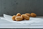 Several potatoes on a piece of paper