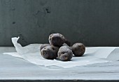 Several violet potatoes on a piece of paper