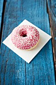 A pink donut with sugar sprinkles