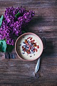 Banana coconut smoothie bowl toppwd with coconut, cacao nibs, goji berries and inka berries