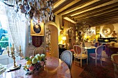 Cafe decorated with antique furniture, paintings and flea-market finds