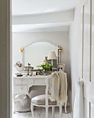 Festively decorated mirror and feminine accessories on white dressing table
