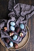 Blue and brown Easter eggs on a cloth