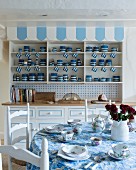 Collection of blue and white crockery in dresser in rustic kitchen