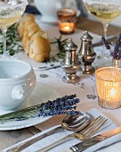 Table festively set with lavender and tealight holders