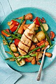 Grilled chicken breast on roasted vegetables