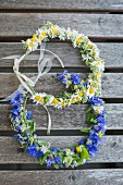 Two floral wreaths on wooden surface