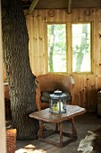 Rustic interior of tree house with tree trunk in one corner