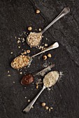 Vintage spoons with oats, chopped hazelnuts, ground almonds and nutella chocolate spread