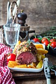 Roast beef with potatoes in crushed almonds and eggwhite