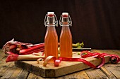 Two glass bottles of homemade rhubarb juice