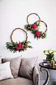 Three wreaths of curved branches with flowers above the sofa