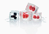 Ice cubes with blueberries and raspberries