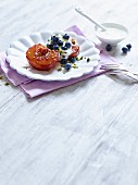 Baked peach with Greek yoghurt, blueberries and pistachios