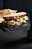 A farmhouse bread sandwich with white radish, red mould cheese and honey
