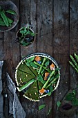 A wild garlic and asparagus tart with salmon (top view)