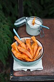 Oven-baked sweet potato fries served with vegan cashew and garlic sauce