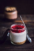 Homemade cheesecake served in the jar on wooden background