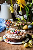 Easter cake with chocolate, meringue and colourful Easter eggs
